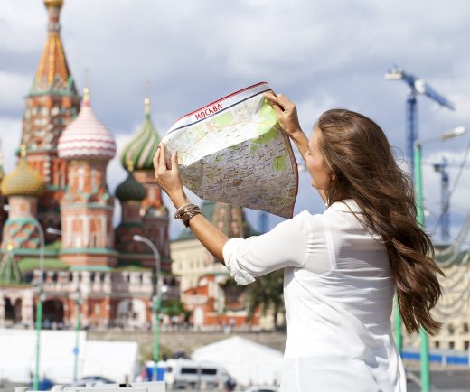 Young beautiful girl holding a tourist map of Moscow